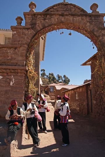 Local men knitting by the archway in the center of Taquile Island, Lake Titicaca 2008
