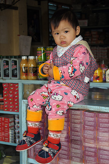 Boy sitting on a store stand, Myitkyina 2016 