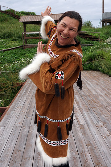 A young Itelmen woman in traditional dress performing a dance movement, Kuril Lake 2016
