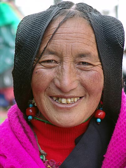 A Tibetan woman with woven hair, on pilgrimage along the Lingkor around the Jokhang, Lhasa, Tibet, China 2004