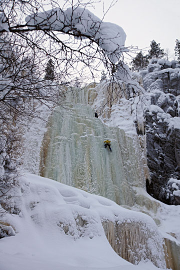 Two ice climbers make their way up the frozen 'Brown River' waterfall at Korouoma canyon, Posio, Finland 2012