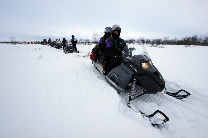 Line of snowmobiles on the frozen Lake Inari, Finland 2012