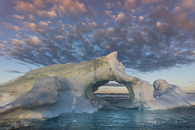 Rays from rising sun illuminate the iceberg, 2017