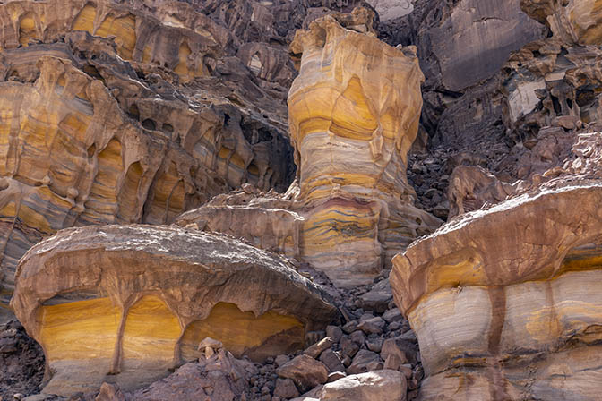 Multicolored sandstone, purple, orange, yellow, red, green, blue and more in the Rainbow Canyon of Wadi Qseib, 2018