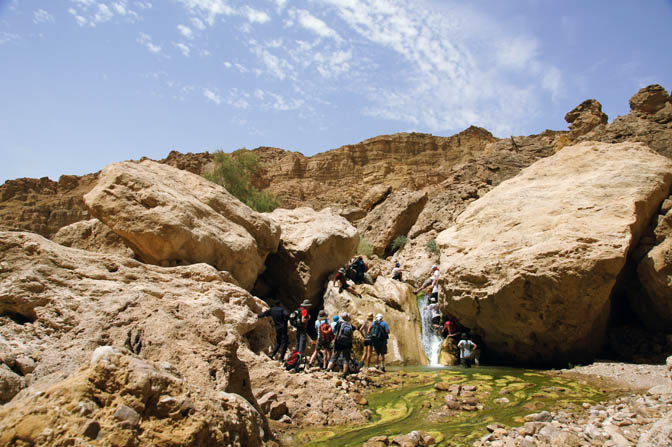 Shapirit group members climb boulders and waterfalls in Wadi Mukheiris, 2012