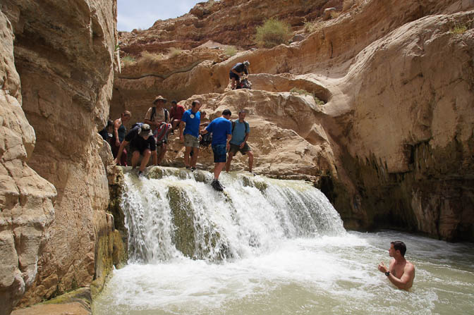 Shapirit group members jump down the waterfall into the warm water of Wadi Zarqa Ma‘in, 2012