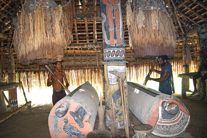 Beating the Garamut drums inside a Haus Tambaran (Spirit House) in Yamok, the Sepik River 2009