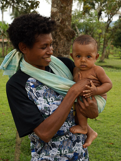 A mother holds her child at Kokoda Station, The Kokoda Trek 2009