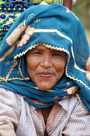 Woman with colorful headdress in the market of Hawariyat Wereda village, 2012
