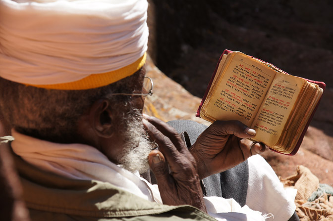 A monk prays in front of a rock-hewn Church, Lalibela 2012