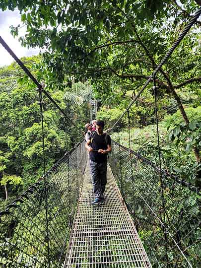 Crossing a suspension bridge in Mistico Arenal Hanging Bridges Park, 2022