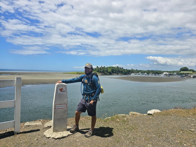 Our great guide Isaac Castro by the last milestone of El Camino de Costa Rica at the Pacific coast, Quepos 2026
