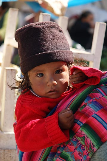A baby girl carried by her mom in the market, Cusco 2008