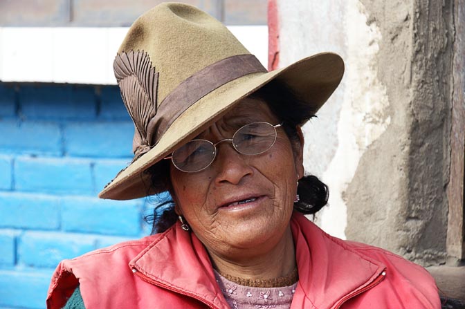 A Chola (local woman) with a ribbon decorated hat on main street, Pachacoto 2008