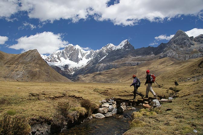 Angel and Aviv are leaping across Waya River, with the north face of Mount Jirishanca at the background, 2008