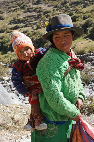 A local woman with a baby tied on her back along the Calinca River, Huayllapa 2008