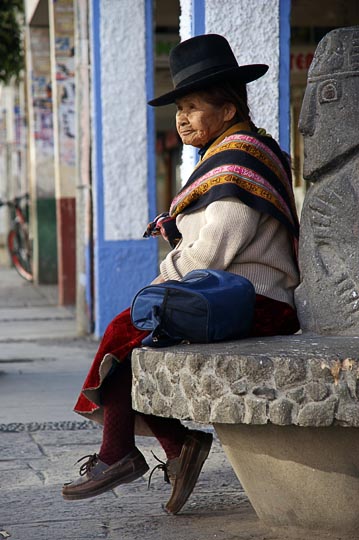 A Chola (local woman) sitting on a bench on main street, Huaraz 2008