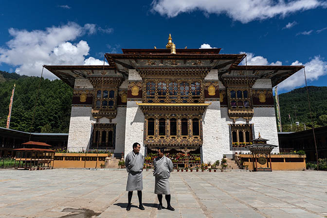 Kezang and Pema dressed in traditional Gho in Kenchosum Lhakhang Monastery courtyard, Jakar, Bumthang 2018