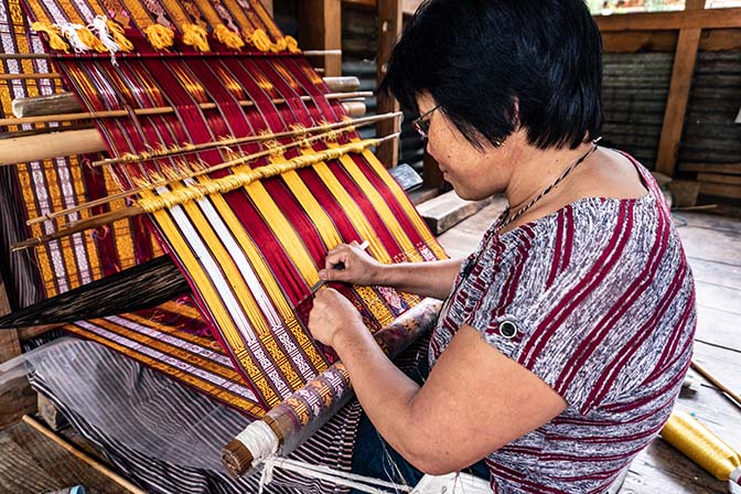 A woman weaving at Khoma village near Lhuntse, Eastern Bhutan, 2018