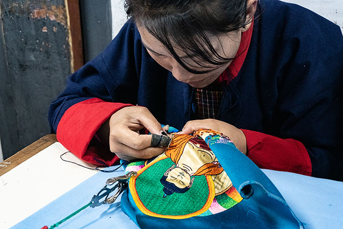 A young woman embroidering at a traditional arts school in Thimphu, 2018