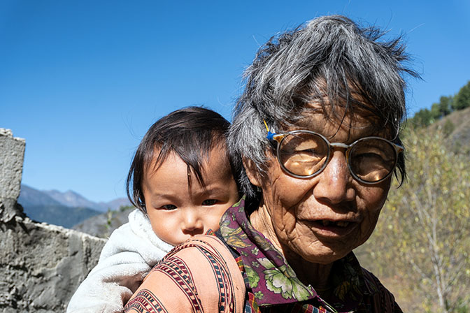 A grandmother carrying her grandson on her back, Haa 2018