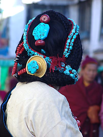 Beads, interlaced in Tibetan woman's hair, along by the Lingkor around the Jokhang, Lhasa 2004