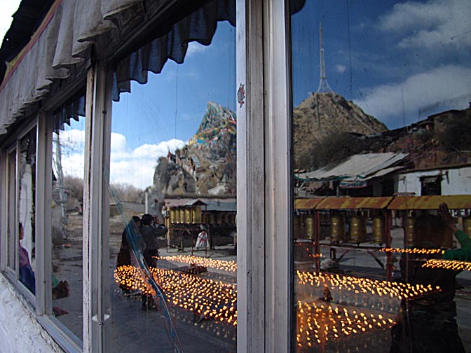 Butter candles, prayer wheels and the Chakpori reflection in the window, Lhasa 2004