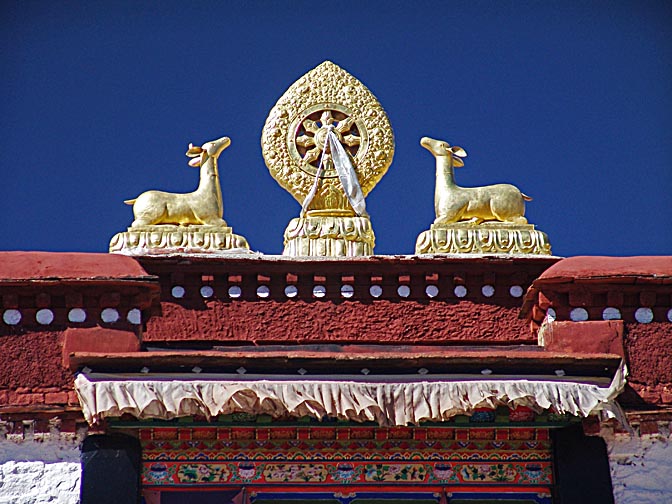 The Dharmacakra, the Wheel of Dharma, a Tibetan Symbol, decorating the top of a temple nearby Lhasa, 2004