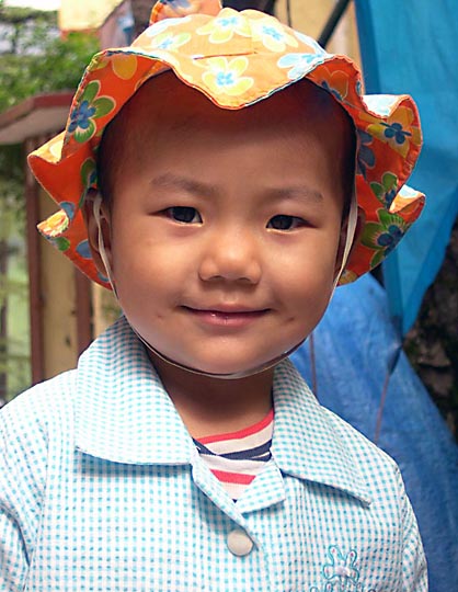 A cute Tibetan kid in Jogiwara road, McLeod Ganj, 2004
