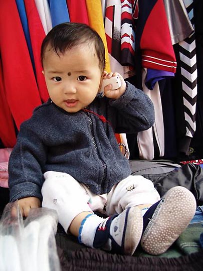 A Tibetan kid, at Jogiwara market in McLeod Ganj, 2004