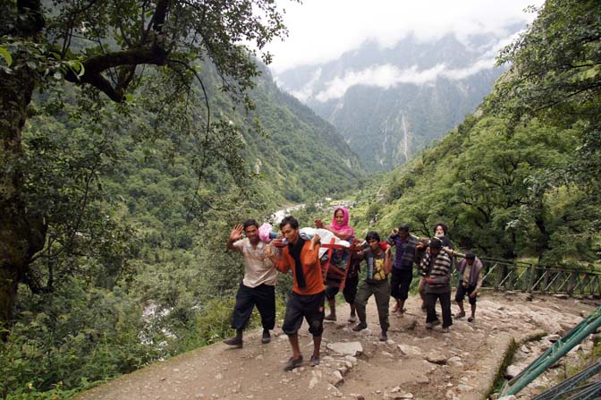 Sikh pilgrims are carried on sedan chairs to the sacred lake Hemkund, Garhwal Himalayas 2011