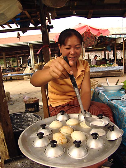A local woman preparing pancakes in the morning market, Vang Vieng 2007