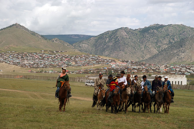 Horsemen come to watch the finish line of the 30 km horse-race, the third game at the Naadam festival, Tsetserleg 2010
