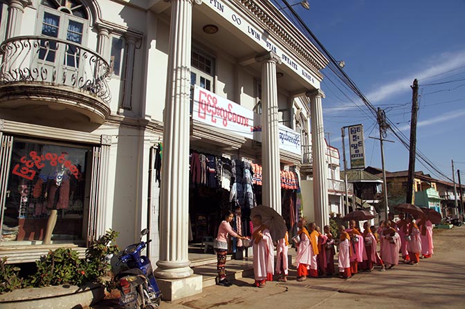 Nuns collect food from shops, in almsgiving Buddhist ritual, Pyin Oo Lwin 2016