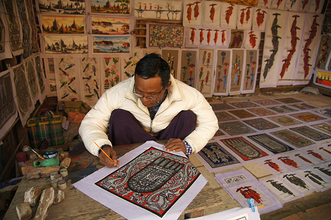 A painter adds color on a print, Bagan 2015