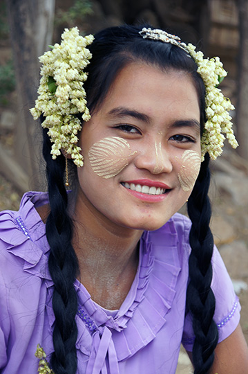 A local girl with traditional Thanaka wood (Hesperethusa crenulata) paste on her face, Innwa 2015