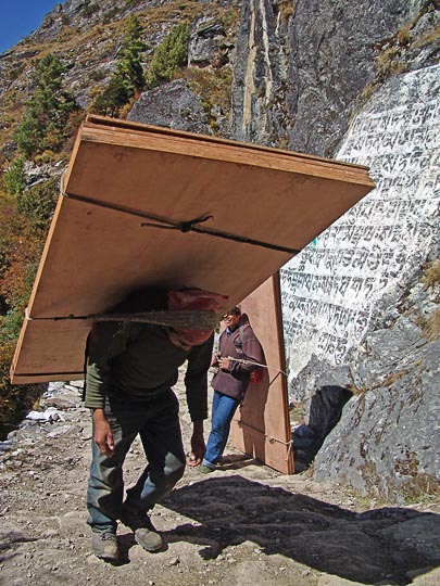 A heavy loaded porter, on the way from Namche Bazaar to Tengboche, 2004