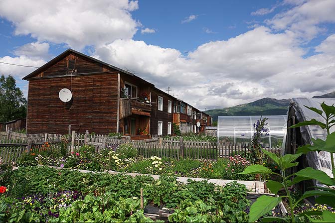 A wooden condo with vegetable plots and greenhouses, Esso 2016