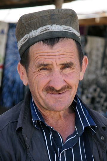 Tajik man wearing a traditional hat in the market, Khushikat 2013