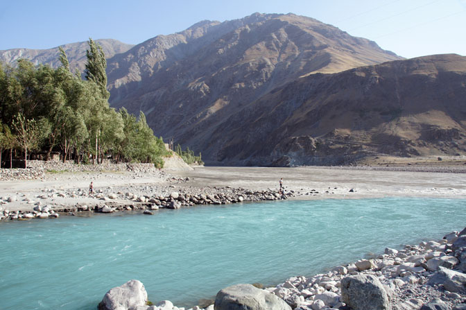 The Blue melting glacier water of the Obikhumbob merge with the flooding brown Panj (Pyandzh) river, Qalai-Khumb 2013