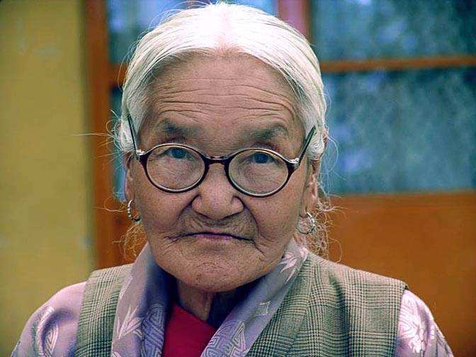 A portrait of a Tibetan woman at The Dalai Lama birthday ceremony, in the Temple in McLeod Ganj, Dharamsala, India 2004