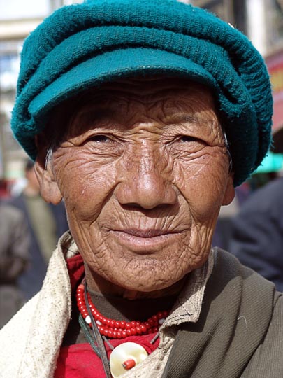 A Tibetan woman on pilgrimage along the Lingkor around the Jokhang, Lhasa, Tibet, China 2004