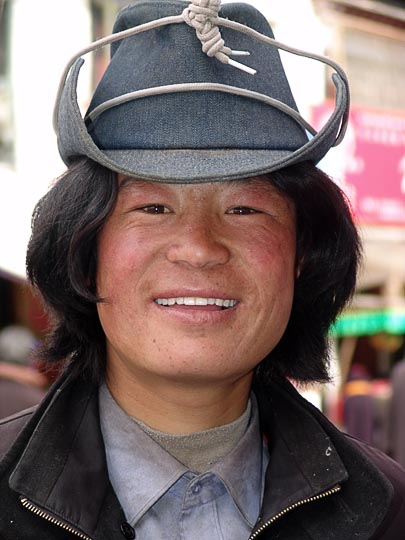 A young Tibetan man on pilgrimage along the Lingkor around the Jokhang, Lhasa, Tibet, China 2004