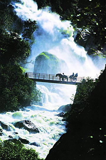 A horse and carriage on a bridge, on the way back from Briksdal Glacier, Norway 1994 (scan)