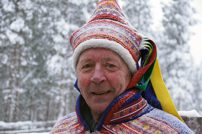 Reima reindeer herder in traditional Sami atire, in the Arctic Reindeer Farm near Rovaniemi, Finland 2012