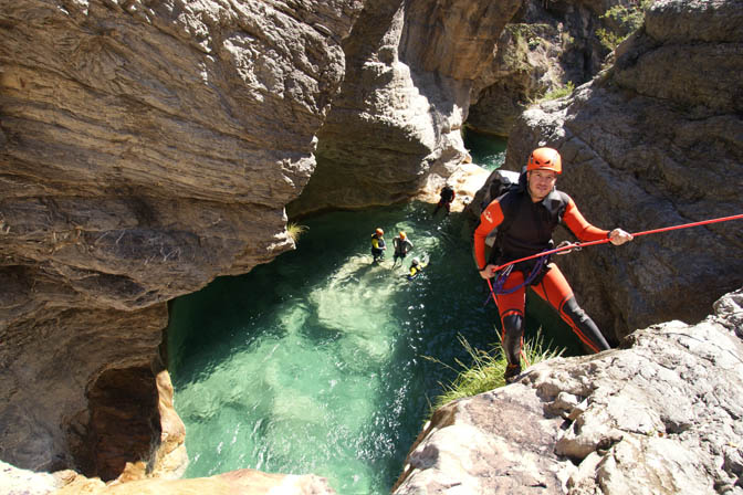 Dudi rappels down (abseils) the rushing waterfall in the Barbaira Canyon, Italy 2011
