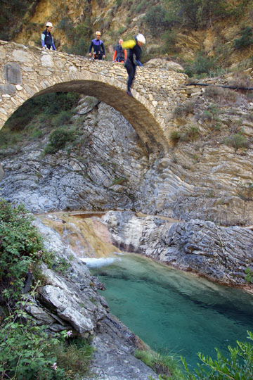 Kobi jumps from the bridge into the clear water of the Barbaira Canyon, Italy 2011