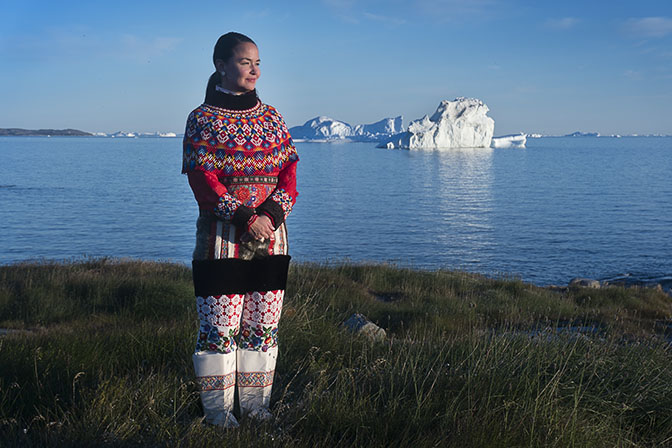 Paarna, an Inuit woman, in traditional outfit on the beach of the village of Rodebay, 2017