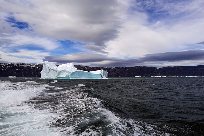 Floating iceberg and foaming trail from the boat, 2017