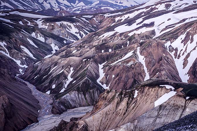 Intermixture of rhyolite colors with ice in golden light, view from Blahnukur mountain, Landmannalaugar 2017